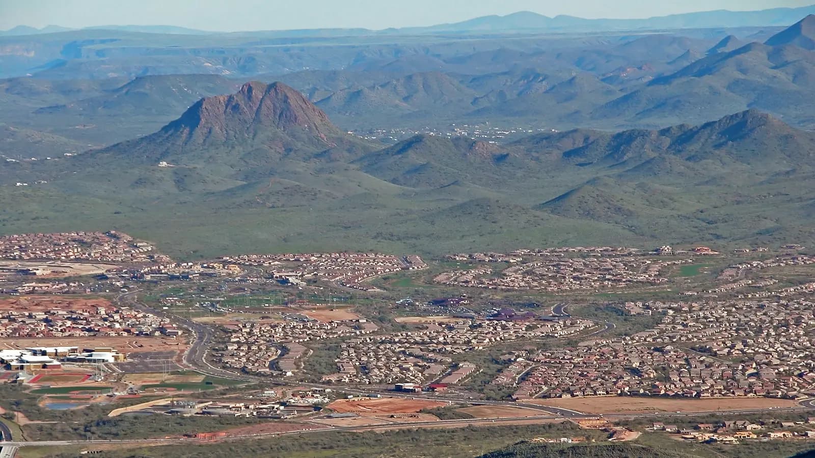 Aerial view of Anthem, Arizona neighborhoods with Gavilan Peak and desert mountains beyond