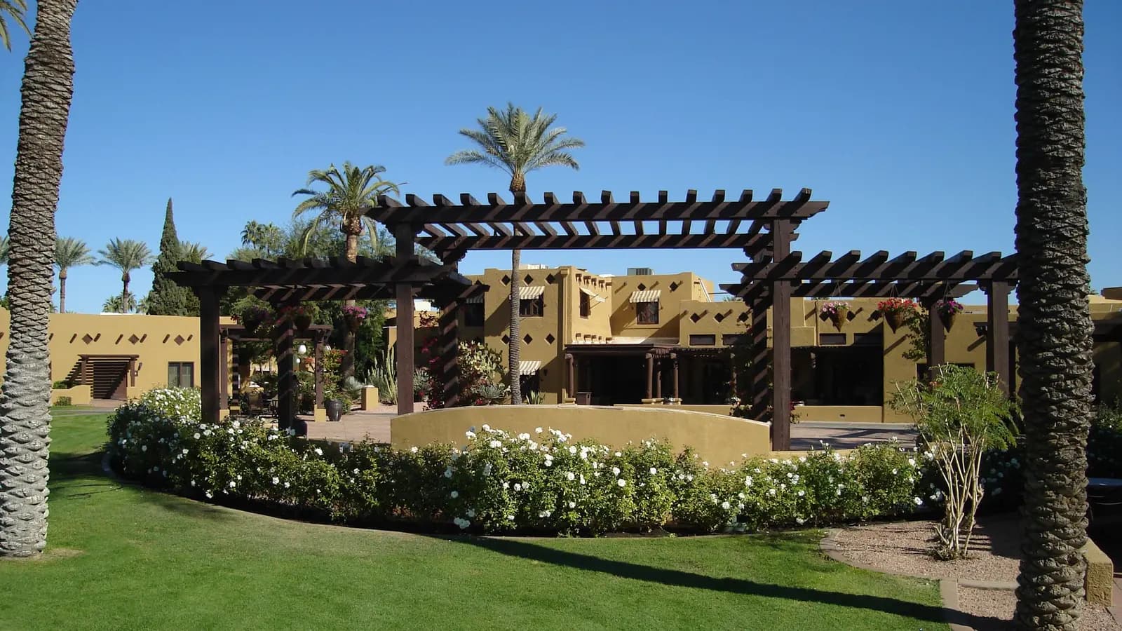 The Wigwam resort's Pueblo Revival buildings, pergola and palms in Litchfield Park, Arizona