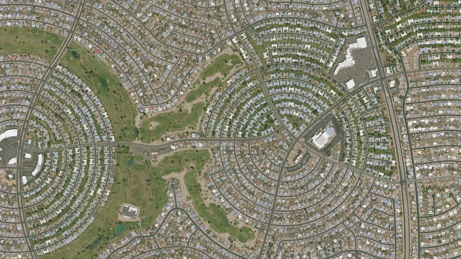 Aerial view of Sun City, Arizona, with circular streets of homes around a recreation center and golf course