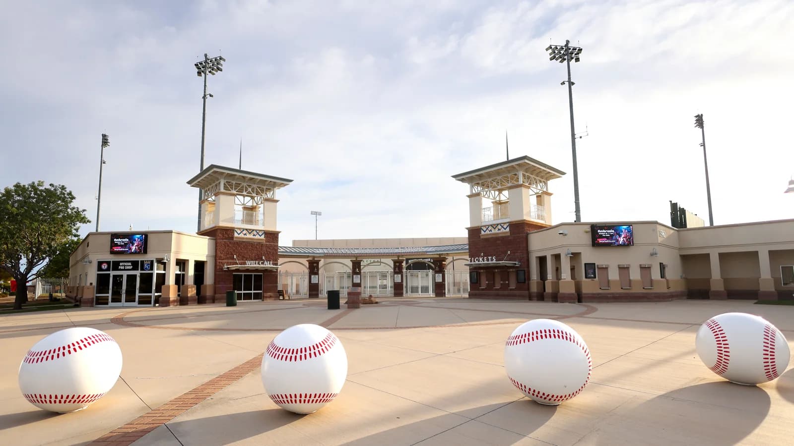 Surprise Stadium entrance plaza with twin towers and giant baseball sculptures in Surprise, Arizona