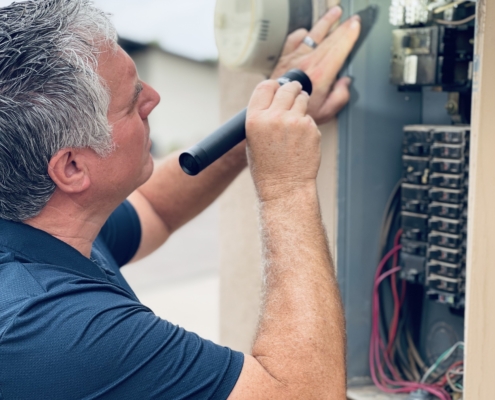 Bob Clardy inspecting an electrical panel